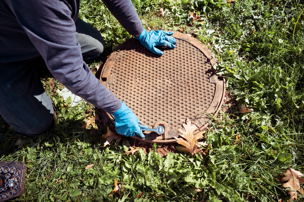 A,Working,Plumber,Opening,Septic,System,Tank.,Copy,Space,For