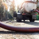 Close-up,Pipe,Hose,Of,Sewage,Truck,Car,Engine,Emptying,Home