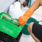 A,Man,Cleaning,A,Grease,Traps,Box,Outside,The,House,